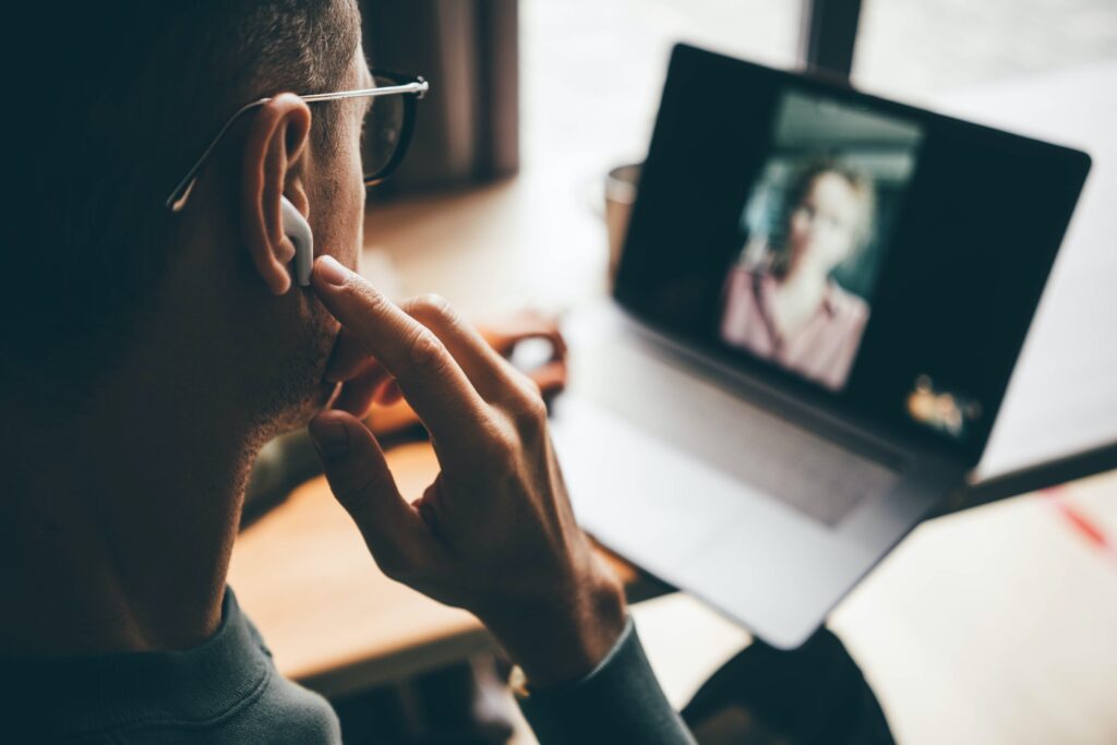 Entrepreneur puts on earphones to join videochat